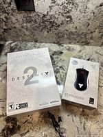 Destiny 2 Limited Edition PC download box and Razer DeathAdder Elite mouse box shown together on countertop.