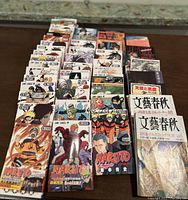 Front view of multiple Naruto manga volumes arranged in rows showing colorful spine artwork and characters.