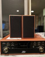 Front view of Pyle Vintage Bluetooth Turntable system with two wooden frame speakers on top, showing black control panel with silver knobs and buttons