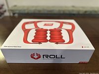 Front angle of sealed box showing the Roll Recovery R8 massage roller image and branding.