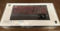 Box of Razer Ornata Chroma keyboard showing front with image of keyboard and branding