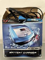 Schumacher XCS15 battery charger shown in original box from front angle.