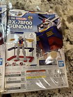 Photo showing one Bandai RX-78F00 Gundam model kit in sealed packaging with front panel displaying the assembled figure and stand.