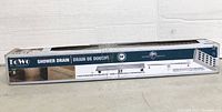 Photo of the 24-inch Towo shower drain in its original box showing product branding and size.
