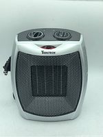 Front view showing silver front with black mesh grille, ToolTech logo, and dual rotary knobs on top.