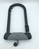 Black and gray Toolway U-lock for bicycles with key attached via zip tie.