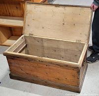 Open view of the antique pine blanket box showing interior and dovetail joints on corners.
