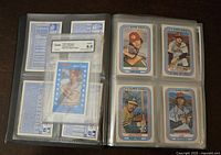 Open album showing 3-D Super Stars baseball cards from Kellogg's, arranged in plastic sleeves, plus one graded card in plastic slab.
