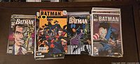Photo showing grouped Batman comic books with visible issues such as Two-Face cover and Knightquest title