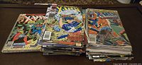 Stacks of Marvel Uncanny X-Men comic books showing covers and spines within the lot.