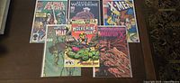 Full lot of six Wolverine and X-Men themed Marvel comic books laid out.