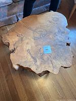 Top-down view of irregular live-edge burl wood slab coffee table