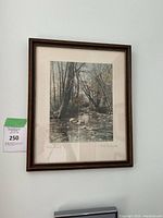 Framed signed artwork titled "Stony Brook" showing a brook with trees and rocks.