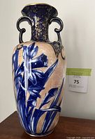 Full side view against neutral background showing twin handles and motif