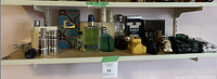 Full view of bottom shelf showing assorted fragrance bottles, boxed colognes, grooming items and novelty decanters
