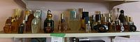 Wide shot of shelf with entire perfume bottle collection