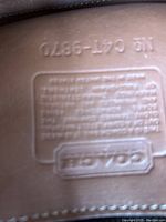 Interior creed stamp reading No G7-9870 and authenticity text