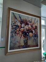 Full view of the framed floral bouquet painting on wall