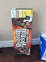 Full boxed Guitar Hero III Legends of Rock game and wireless guitar controller for PlayStation 2. Box features colorful artwork and branding.