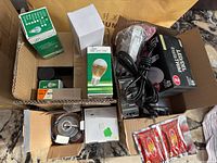 Photo showing various boxed LED high power lamp bulbs and assorted other lightbulbs and accessories in cardboard boxes.