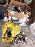 Box and yellow bag containing electrical components, wires and adapters