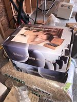 Two boxes of Deluxe Warm Stone Massage Sets stacked, showing product packaging with image of a woman receiving a warm stone massage.