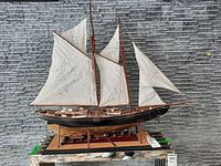 Full side view of wooden model ship on display stand