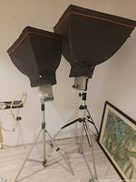 Two Elinchrom studio flash lights with softboxes mounted on tripods in indoor setting