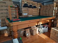 Full view of pool table with green felt and surrounding accessories