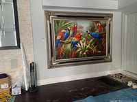 Front view of large framed canvas print hanging on gray wall above hardwood floor