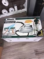 Box of the Shark Professional Portable Hard Surface Steam Cleaner showing product image, brand, and usage details.