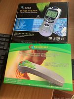 Photo of boxed Digital Therapy Machine and Accuciser Ultrasound Massager showing packaging and device images