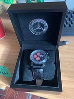 View of the Mercedes Benz watch in black box, showing branded interior and watch cushion.