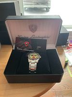 Watch in open Tonino Lamborghini case with warranty card/manual