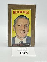 Front of 1964-65 Topps TallBoy Sid Abel hockey card showing portrait with yellow Red Wings background.