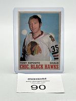Front of Tony Esposito card in protective case showing the player in Chicago Black Hawks uniform.