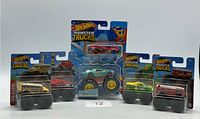 Five Hot Wheels Monster Trucks in original packaging arranged in a row