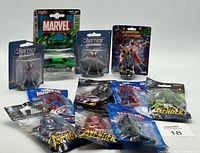 Lot overview showing all 11 Marvel and DC collectibles including figures and die-cast car.