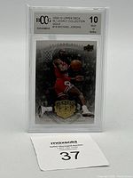Front view of the Michael Jordan graded card with BCCG 10 rating, showing card's design of Jordan dunking and gold emblem.