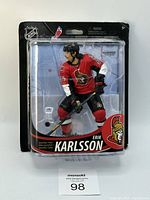 Front view of sealed McFarlane NHL Series 33 Erik Karlsson figure in Ottawa Senators red jersey with clear plastic packaging and black backing card.