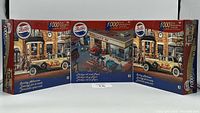 Three boxed Pepsi-Cola themed puzzles displayed side by side, showing the artwork on the front.