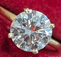 Close-up top view of round brilliant diamond in four-prong 10K yellow gold setting