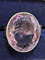 Top view showing the faceted oval amethyst gemstone with light purple hues in a silver setting.