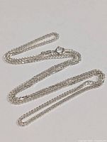 16 inch silver chain necklace fully laid out showing chain links and clasp.