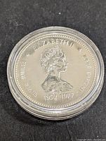 Silver Jubilee Elizabeth II Canadian Dollar Coin showing Queen Elizabeth II profile dated 1952-1977.