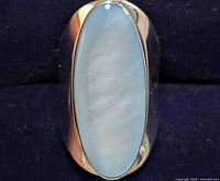 Top view showing elongated oval mother of pearl in polished silver bezel setting.