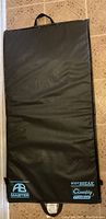 Top view of the black exercise mat laid flat showing two handles and textured surface