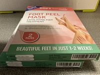 Two boxes of Soft Touch Foot Peel Mask, each containing two pairs of exfoliating foot mask for treatment.