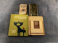 Five Jewish-themed books placed on a gray carpet background. Titles are 'Great Jewish Short Stories,' 'To Be a Jew,' 'Northern Lights: A Canadian Jewish History,' and 'The Jewish Experience' showing an illustrated historical and cultural design on covers.