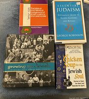 Four Jewish-themed books arranged on a gray surface, showing front covers and titles clearly.